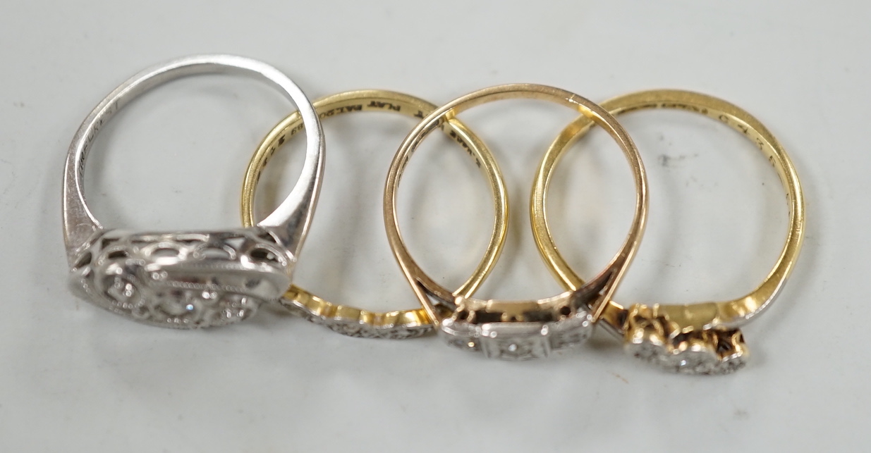 Two 18ct, plat and illusion set three stone diamond rings and two other similar white metal rings, one stamped 9ct